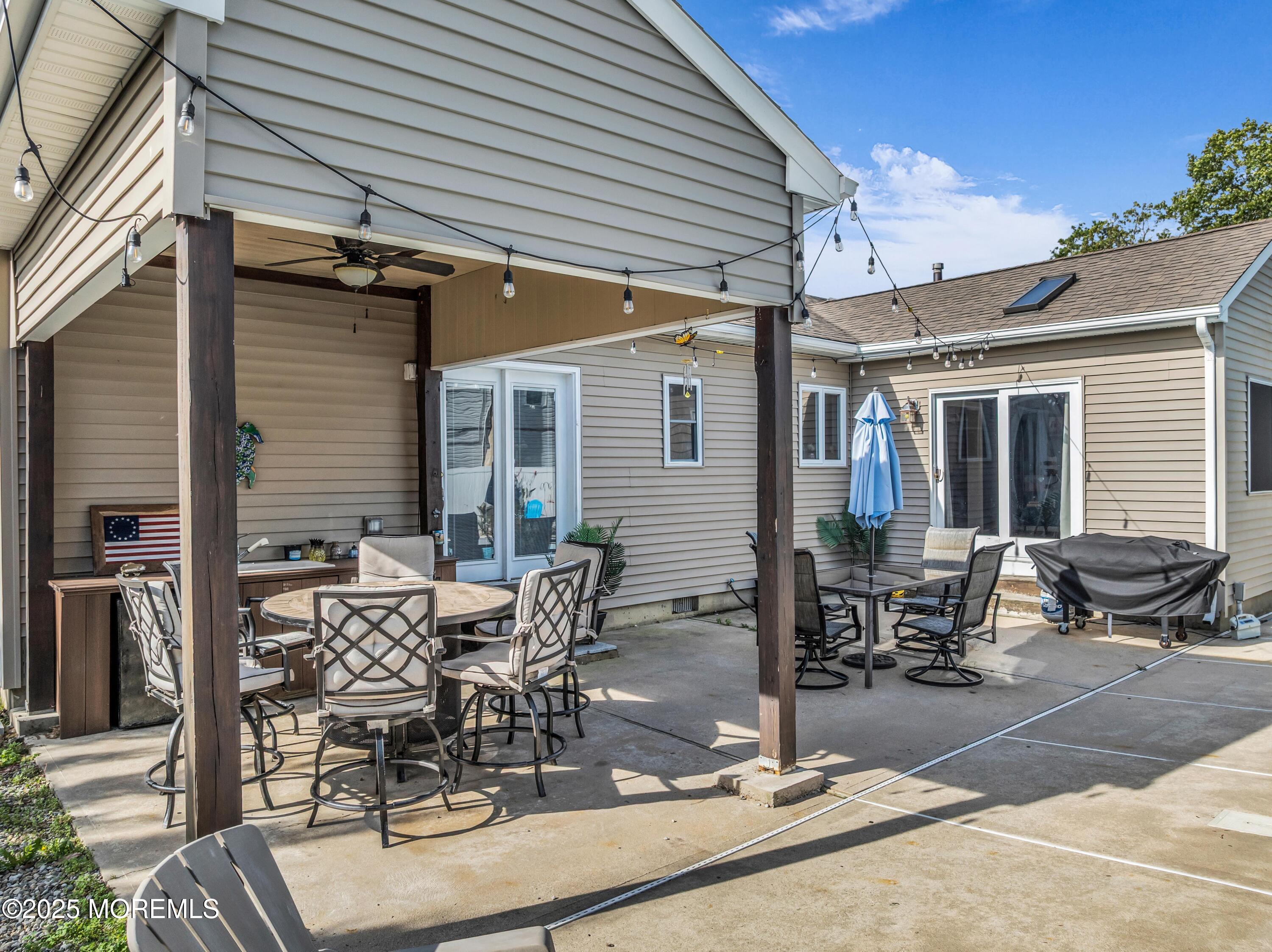 910 Alpine Street Forked River, NJ 08731 - Photo 25 of 32 a view of a patio with table and chairs and potted plants