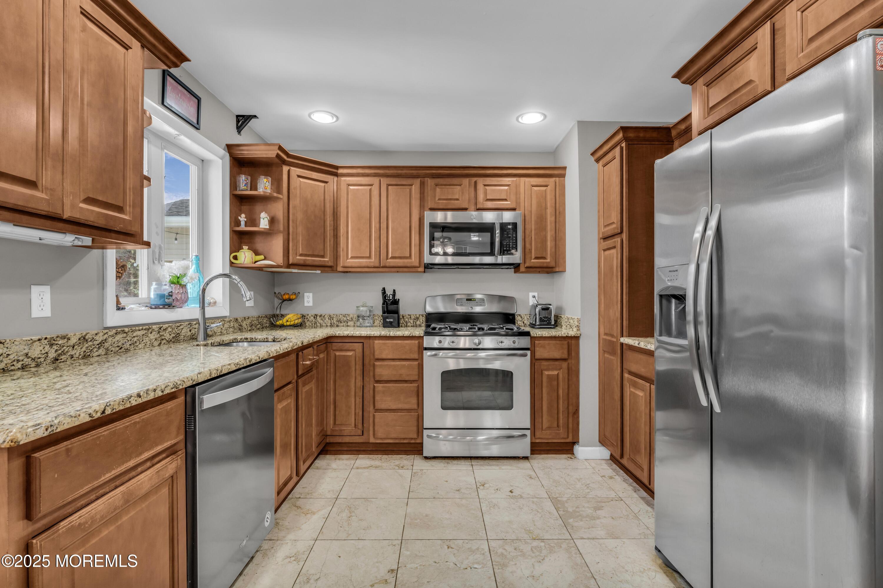910 Alpine Street Forked River, NJ 08731 - Photo 7 of 32 a kitchen with stainless steel appliances granite countertop a refrigerator stove and a sink