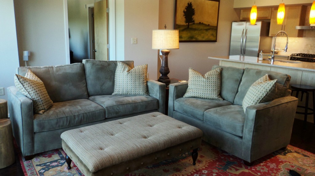a living room with furniture and a lamp