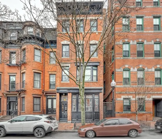 a front view of a building with parking space