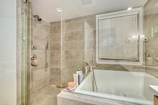 a bathroom with a tub and shower