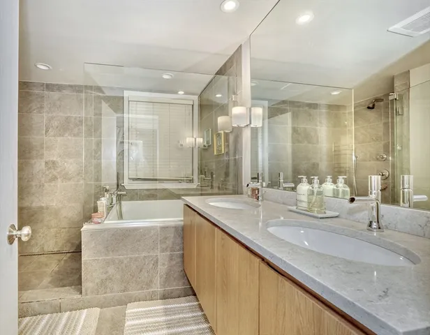 a bathroom with double vanity sinks and a large mirror