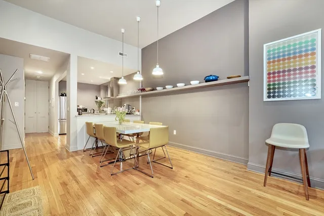 a view of a dining room with furniture and wooden floor