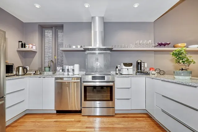 a kitchen with cabinets a sink and appliances