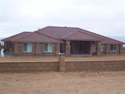 24634 Tussing Ranch Road Apple Valley, CA 92308 - Photo 1 of 1 a front view of a house with a garden