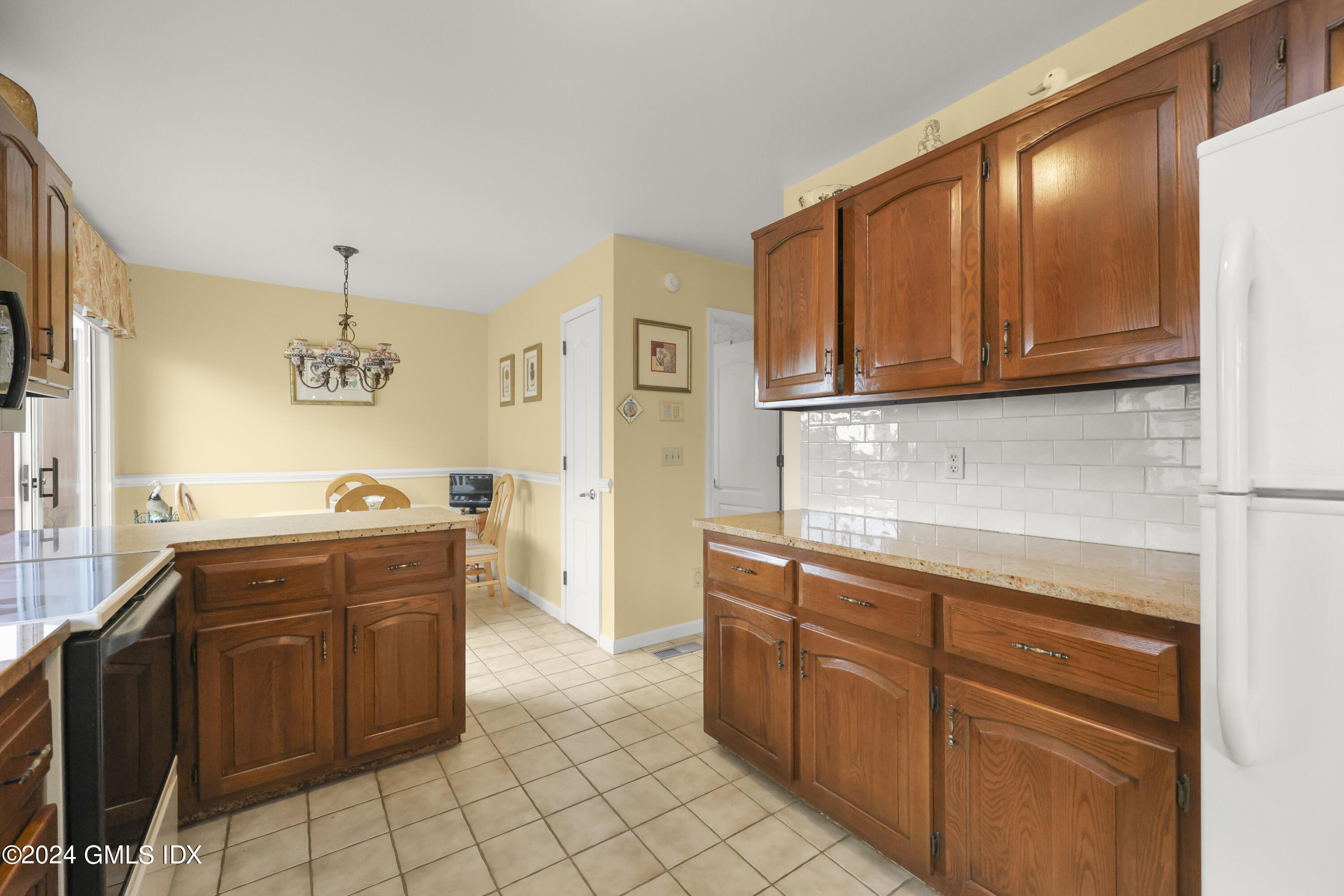 162 Colonial Road, Unit 12 Stamford, CT 06906 - Photo 12 of 38 a kitchen with stainless steel appliances granite countertop a stove a sink and a microwave