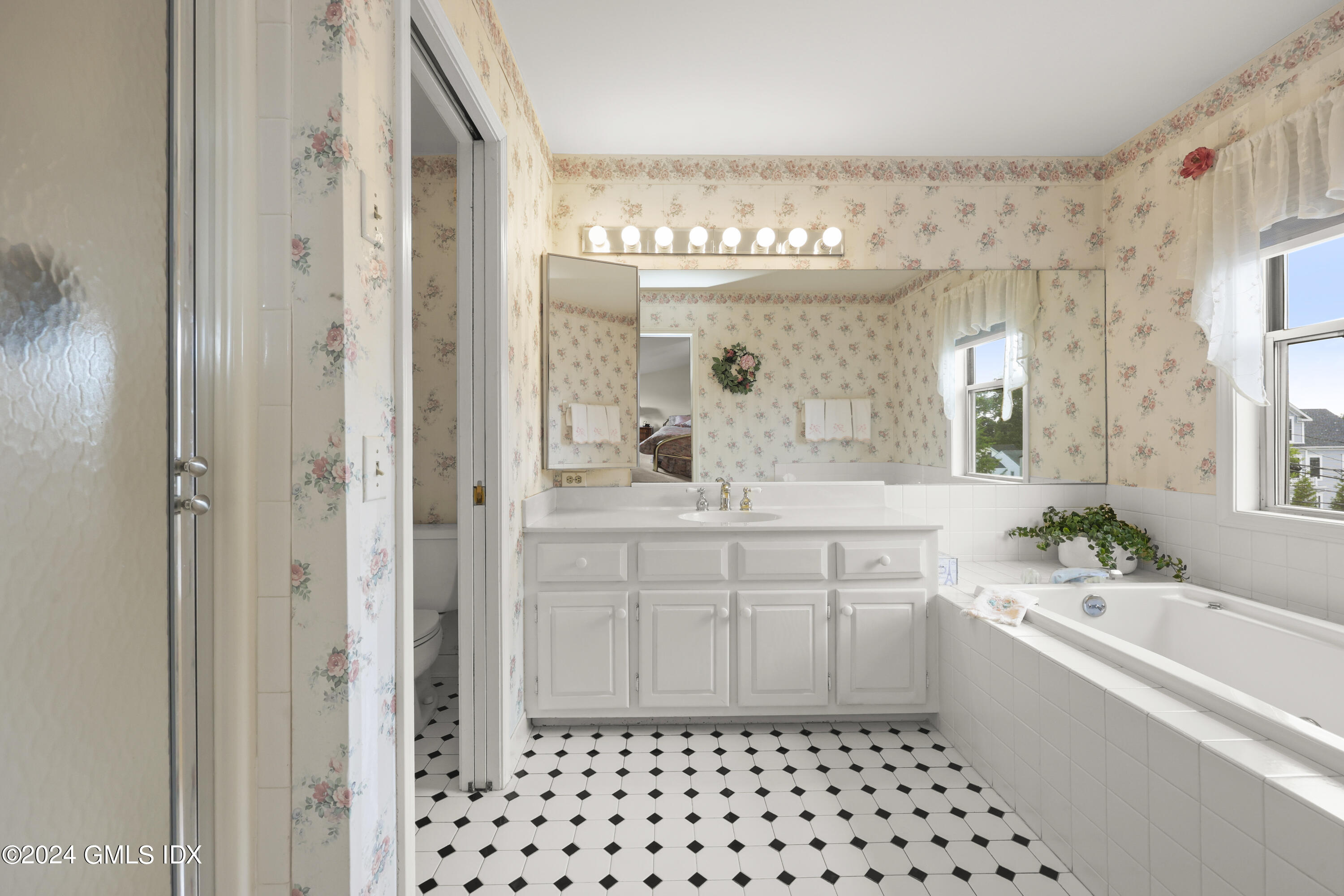 162 Colonial Road, Unit 12 Stamford, CT 06906 - Photo 27 of 38 a bathroom with a sink a large mirror and a shower