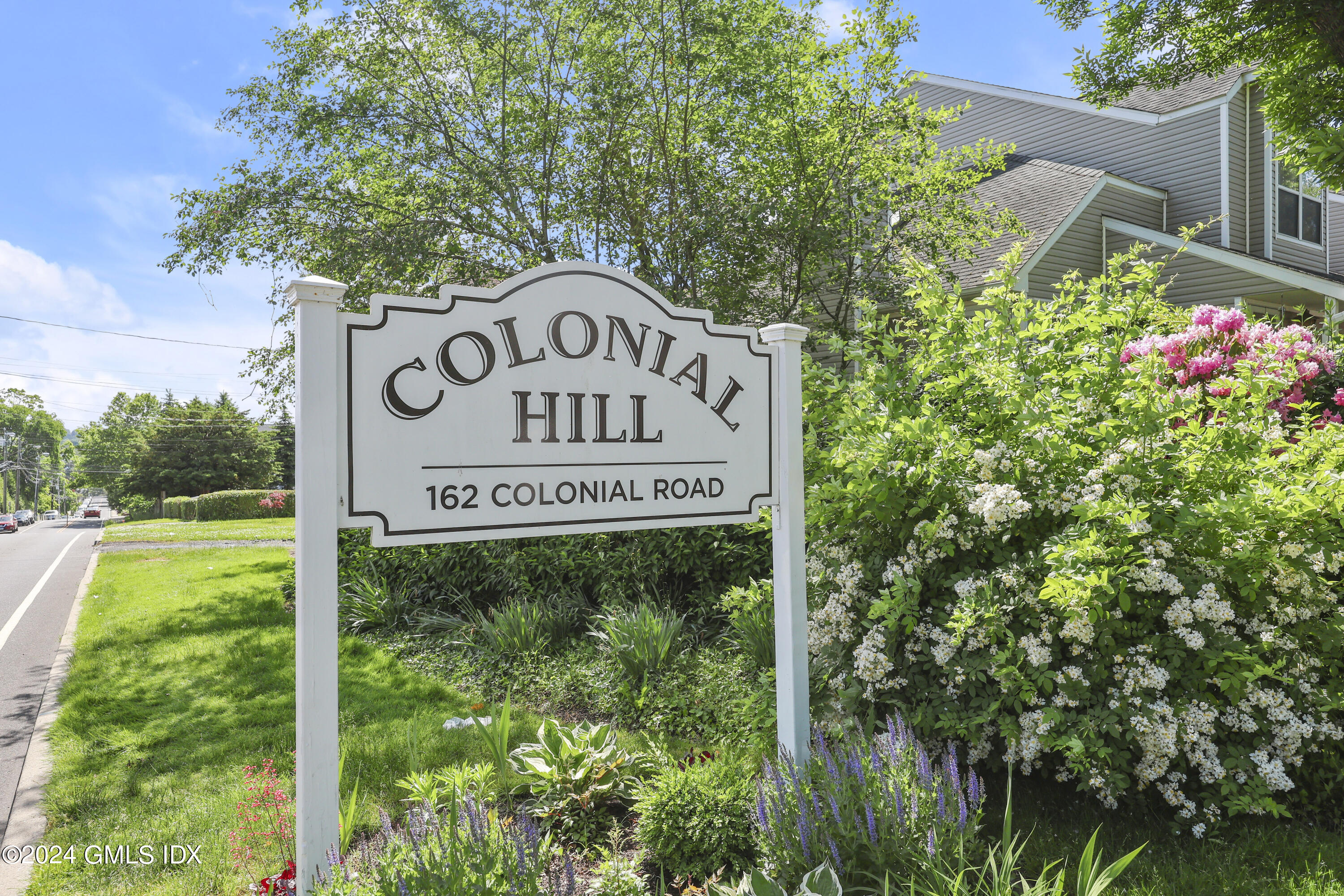 162 Colonial Road, Unit 12 Stamford, CT 06906 - Photo 34 of 38 a sign broad on the side of the road