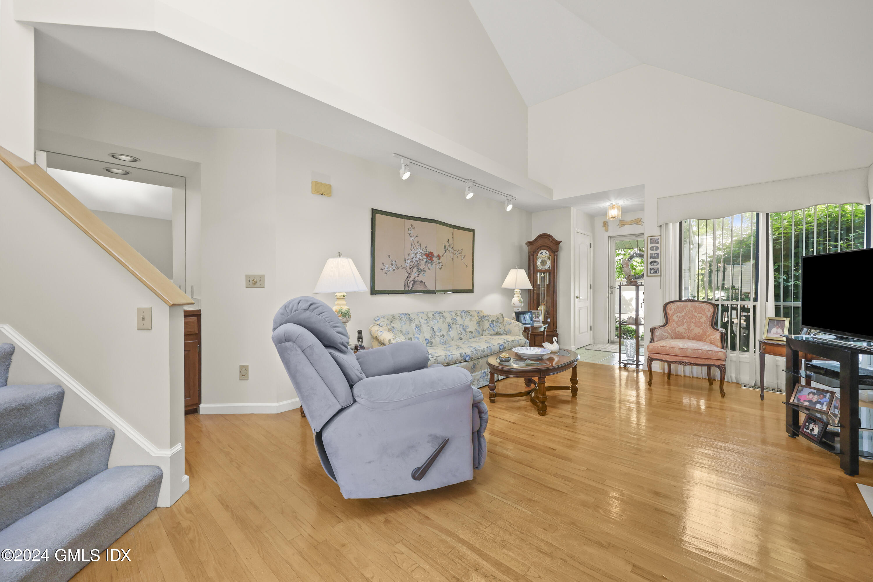162 Colonial Road, Unit 12 Stamford, CT 06906 - Photo 7 of 38 a living room with furniture and a flat screen tv