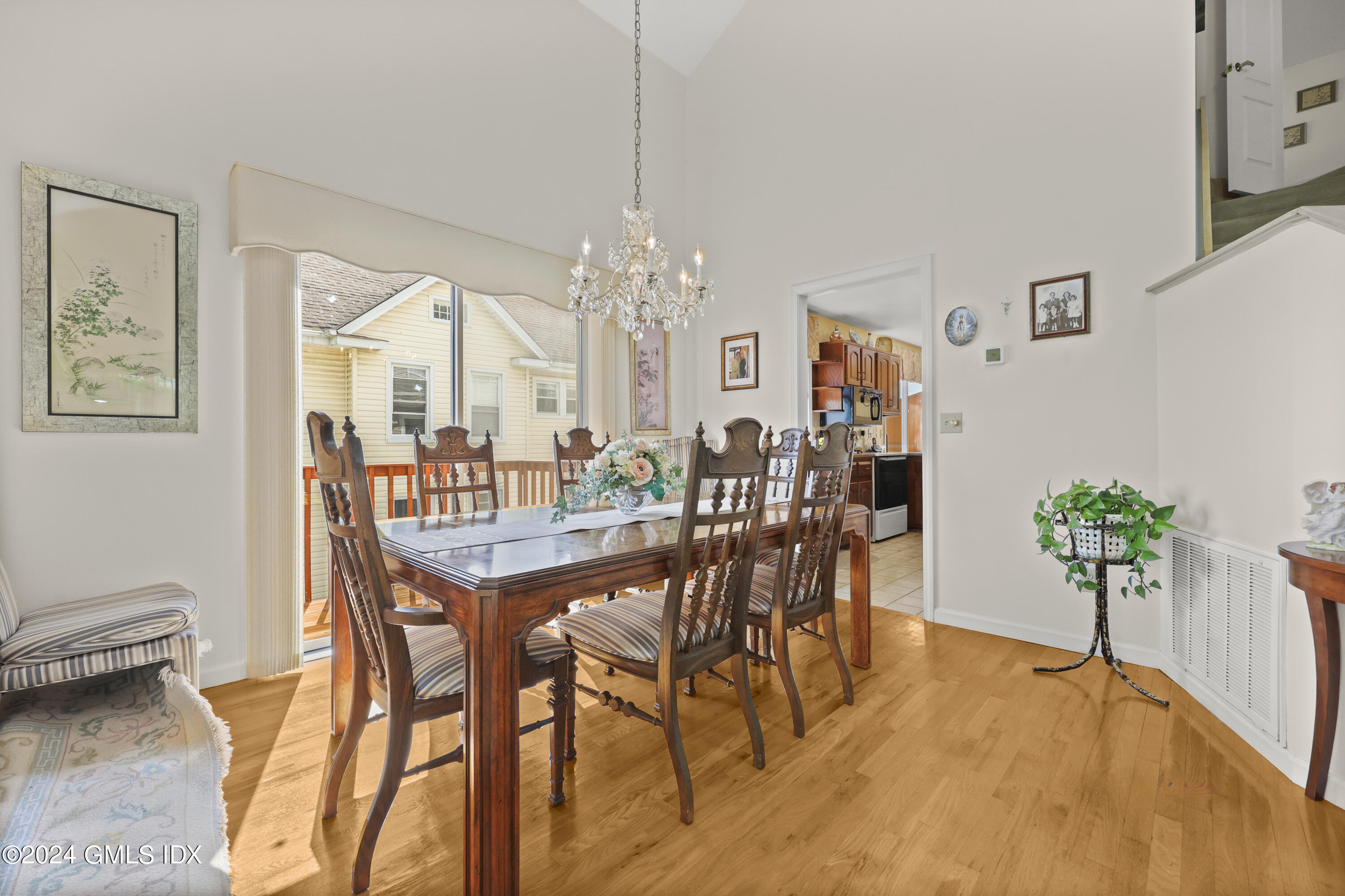 162 Colonial Road, Unit 12 Stamford, CT 06906 - Photo 9 of 38 a view of a dining room with furniture and chandelier