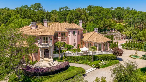 a front view of a house with a yard table and chairs
