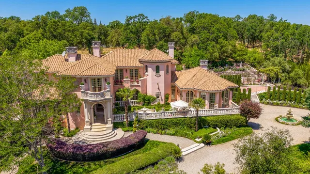 a front view of a house with a yard table and chairs