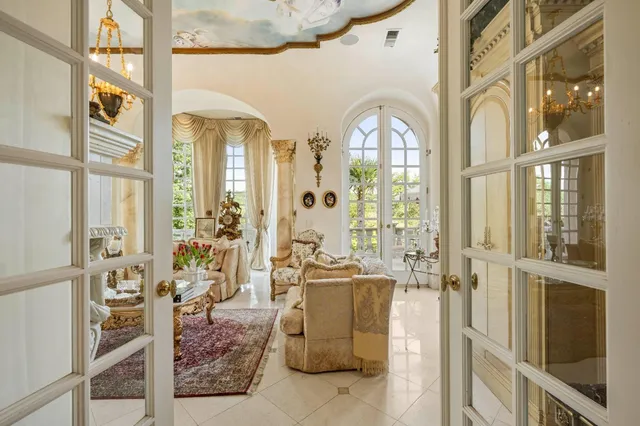 a kitchen with stainless steel appliances kitchen island granite countertop a table chairs and cabinets