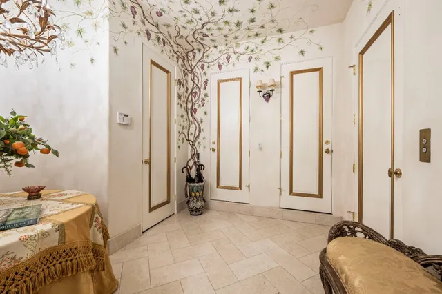 a front view of a house with a yard and potted plants