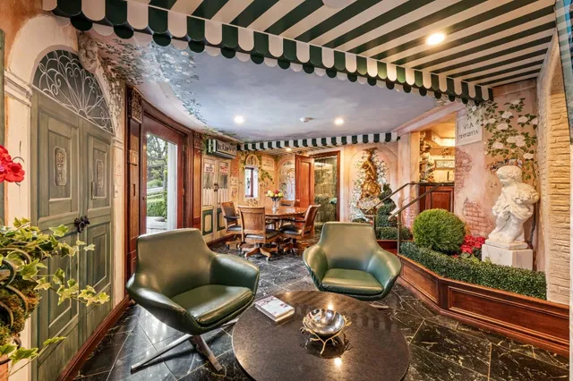 a view of a patio with couple of chairs and potted plants