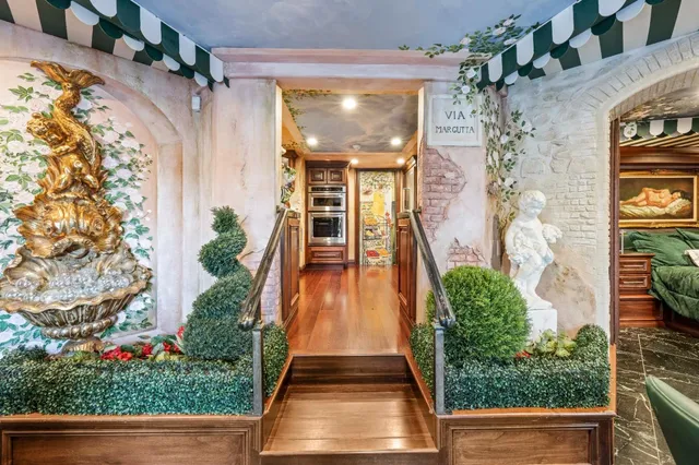 a patio with table and chairs and potted plants