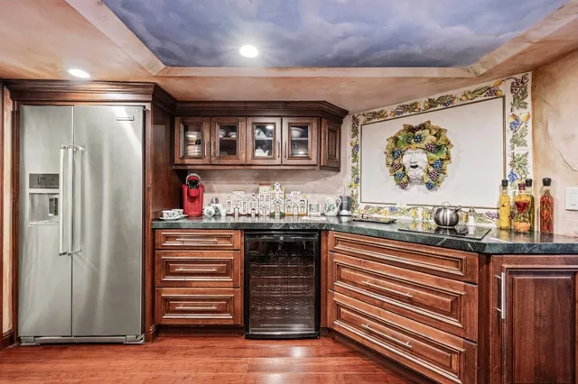 a view of a yard with plants and large trees