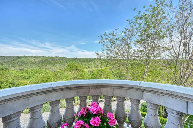 front view of a brick house with a yard