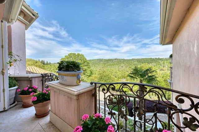 a view of a table and chairs in a garden