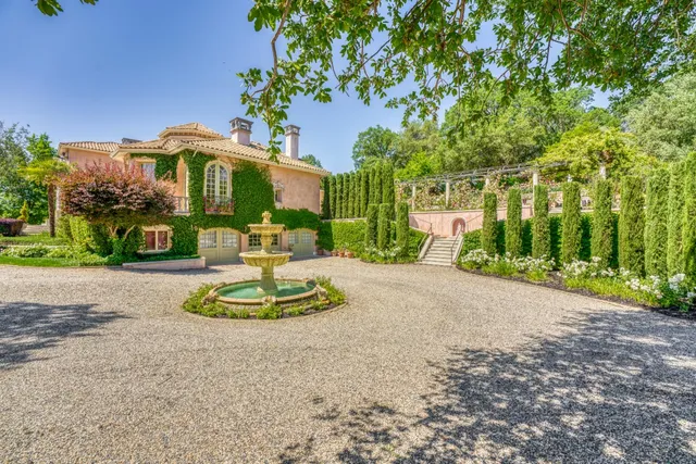 an aerial view of a house with yard and green space