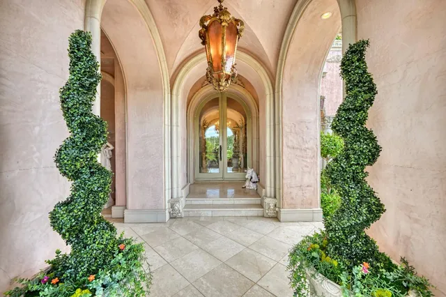 a living room with furniture chandelier and a fireplace