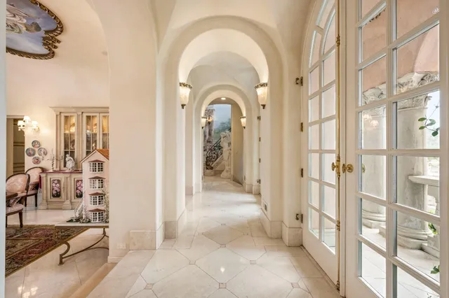 a bedroom with furniture and a large window