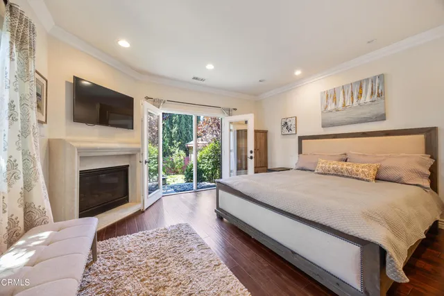 a bedroom with a large bed and a fireplace