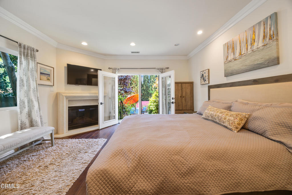 1291 Wesley Avenue Pasadena, CA 91104 - Photo 19 of 46 a spacious bedroom with a bed and a flat screen tv