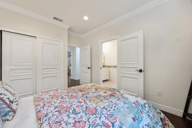 a bedroom with a bed and a dresser