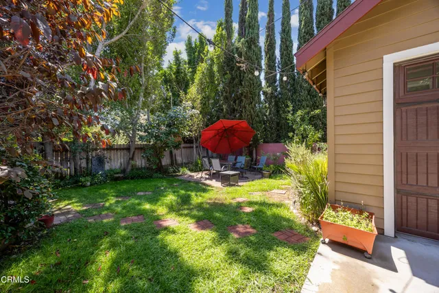 a front view of house with yard and outdoor seating