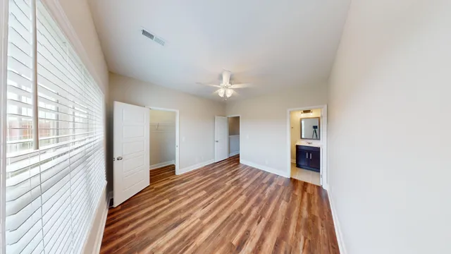 a spacious bathroom with a granite countertop sink toilet and shower