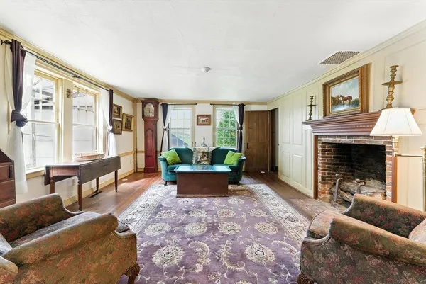 a living room with furniture and a fireplace