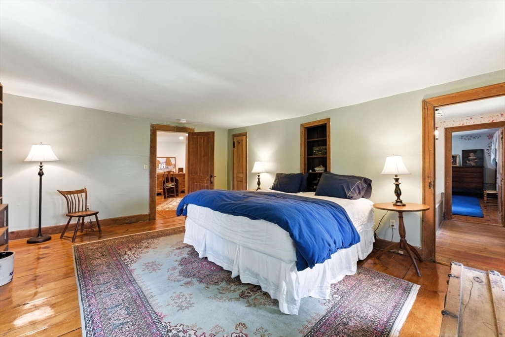 85 Dacey Road Conway, MA 01341 - Photo 26 of 42 a bedroom with a bed a table and chair