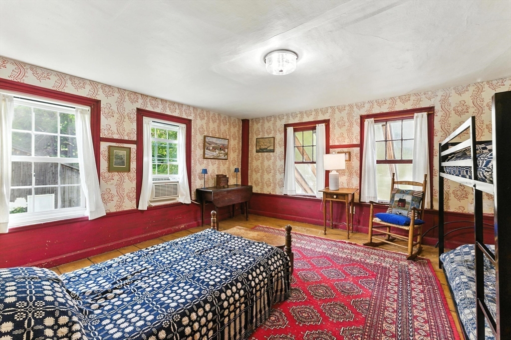 85 Dacey Road Conway, MA 01341 - Photo 31 of 42 a bedroom with a bed and wooden floor