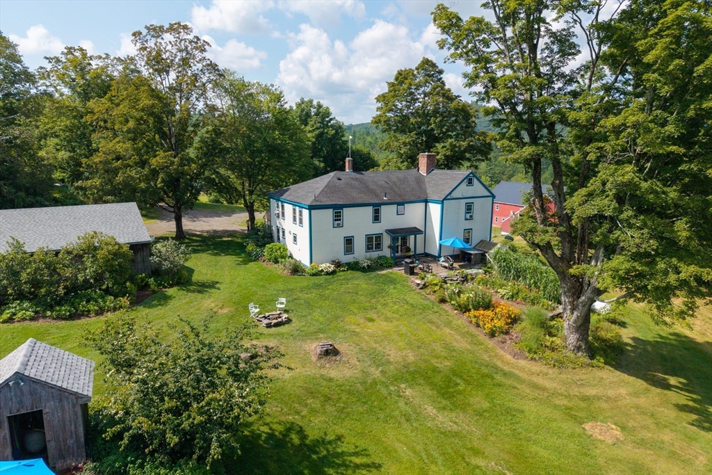 85 Dacey Road Conway, MA 01341 - Photo 4 of 42 a view of a house with a big yard and large trees