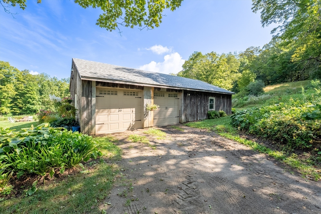 85 Dacey Road Conway, MA 01341 - Photo 5 of 42 a front view of a house with a yard