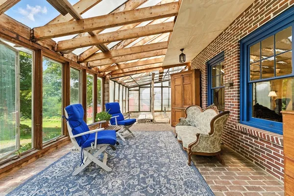 a living room with furniture and a floor to ceiling window