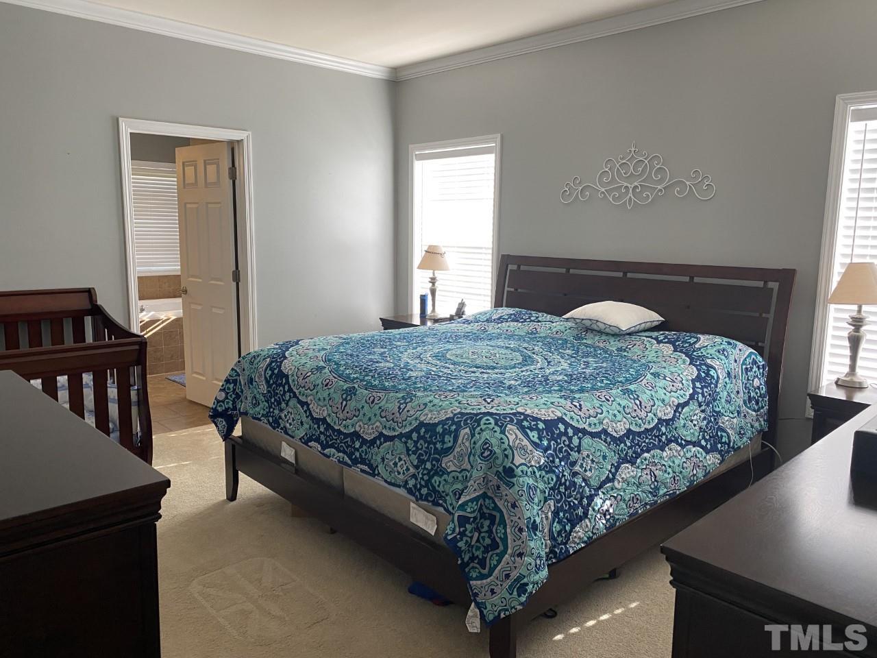 274 South Chaucer Way Kittrell, NC 27544 - Photo 13 of 28 a bed sitting in a bedroom next to a window