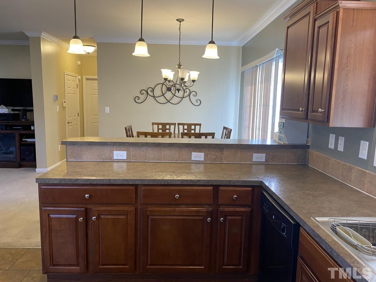 274 South Chaucer Way Kittrell, NC 27544 - Photo 4 of 28 a kitchen with granite countertop stainless steel appliances and wooden cabinets
