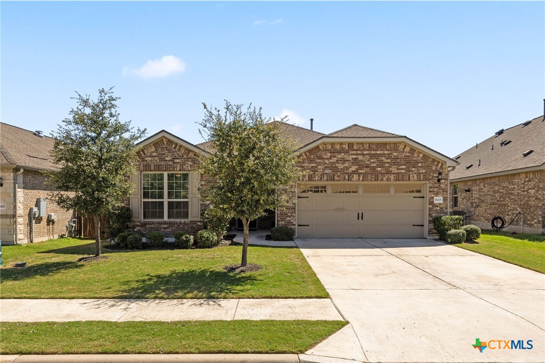 18215 Winnow Way Pflugerville, TX 78660 - Photo 1 of 21 a front view of a house with a yard