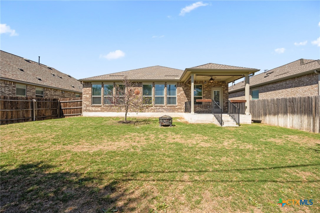 18215 Winnow Way Pflugerville, TX 78660 - Photo 20 of 21 a front view of a house with a yard balcony and glass top table and chairs