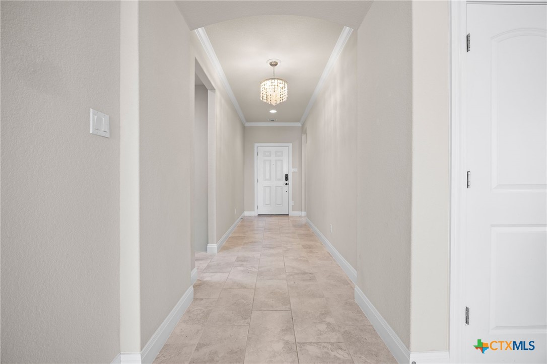 18215 Winnow Way Pflugerville, TX 78660 - Photo 4 of 21 a view of a hallway with wooden floor