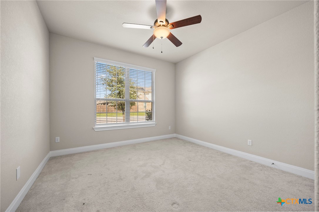 18215 Winnow Way Pflugerville, TX 78660 - Photo 8 of 21 an empty room with windows and fan