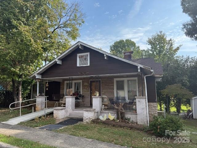 a front view of house with yard and outdoor seating