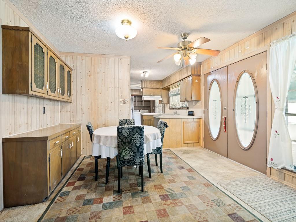 1081 Wright Street Terrell, TX 75160 - Photo 11 of 29 Dining area with patterned flooring, wood paneling, and a built-in cabinetry unit