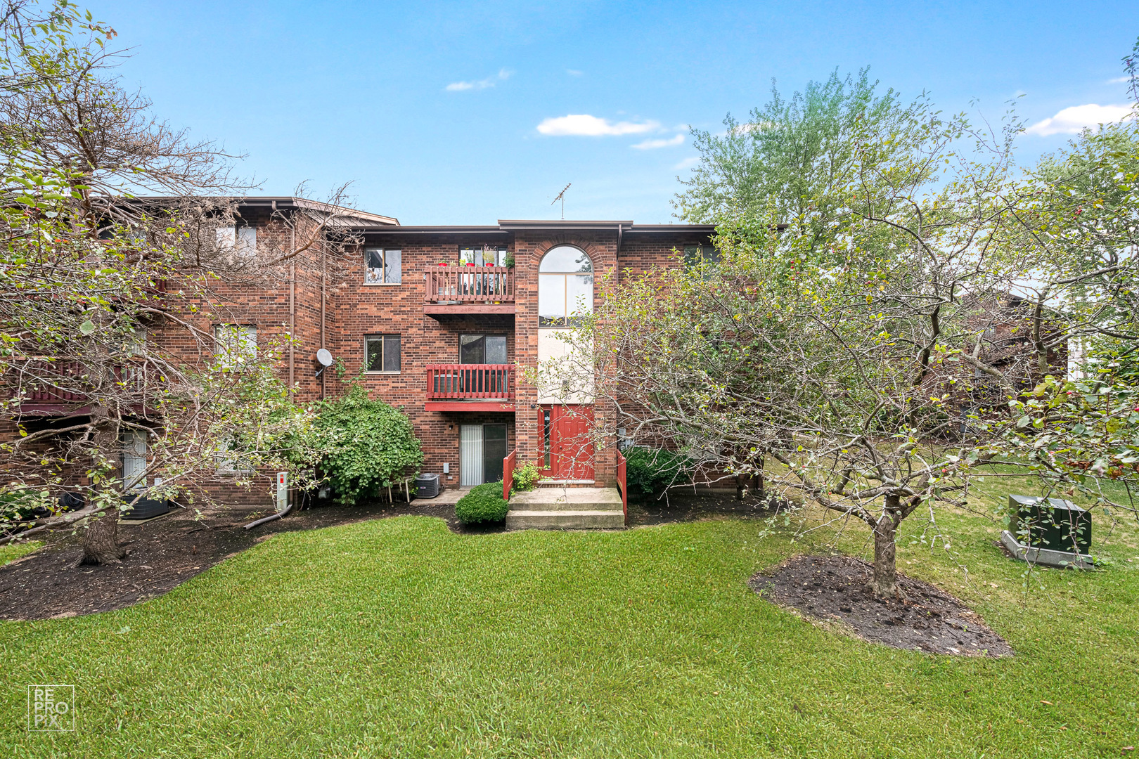 720 Inland Circle, Unit 102 Naperville, IL 60563 - Photo 1 of 1 a front view of a house with a yard