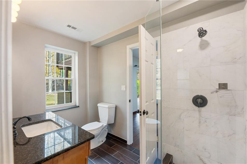 14440 Cogburn Road Alpharetta, GA 30004 - Photo 42 of 62 a bathroom with a sink toilet and shower