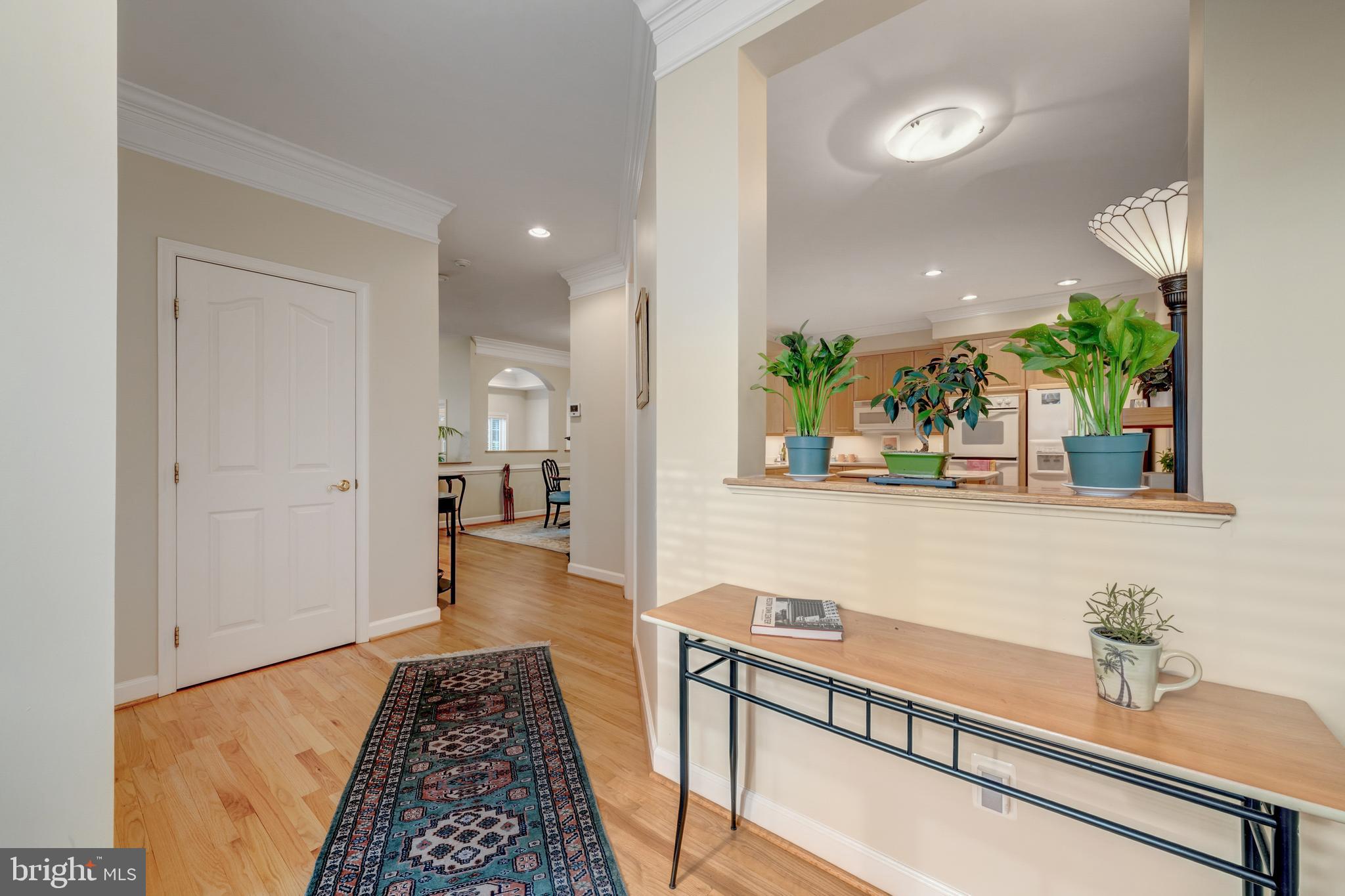 1925 Logan Manor Drive Reston, VA 20190 - Photo 6 of 61 a hallway with a large mirror and a potted plant