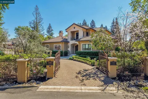 a view of a house with a tub and trees in the background