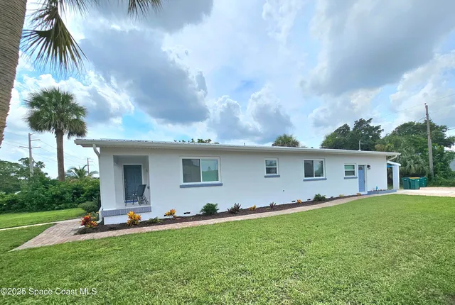 a front view of house with yard and outdoor seating